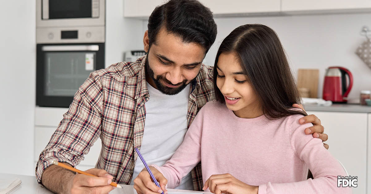 financial-literacy-for-kids father-teaching-daughter-money-management